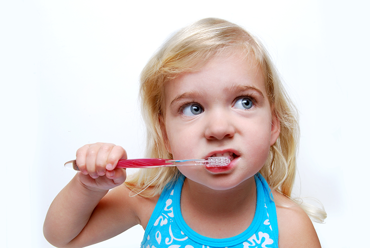 girl brushing teeth